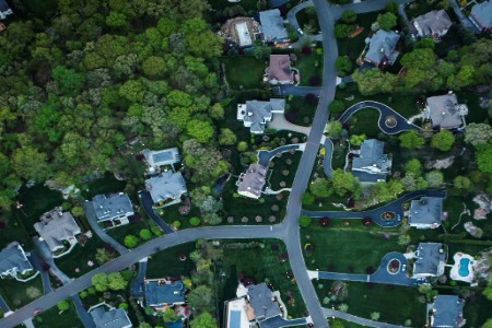 aerial view of houses, roads, trees